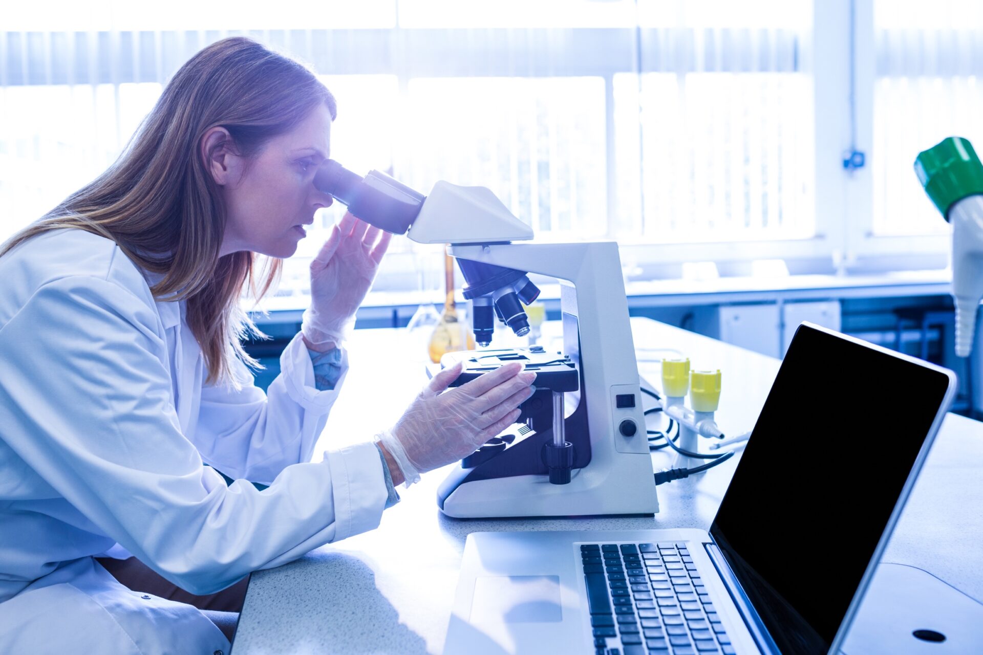 A researcher working at a microscope in the Drorys R&D lab